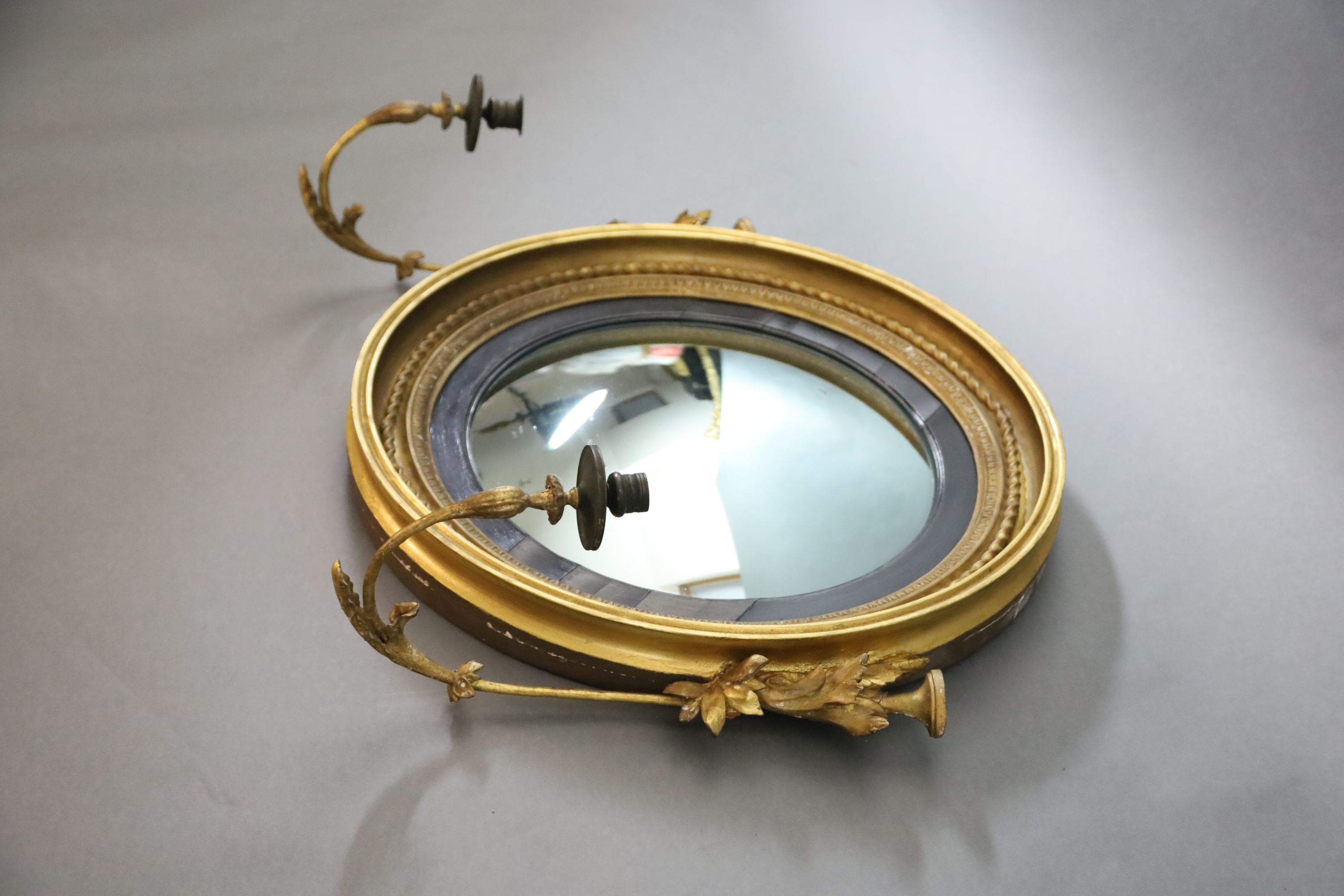 A William IV giltwood and gesso convex girandole, W.2ft 7in. H.2ft 2in.